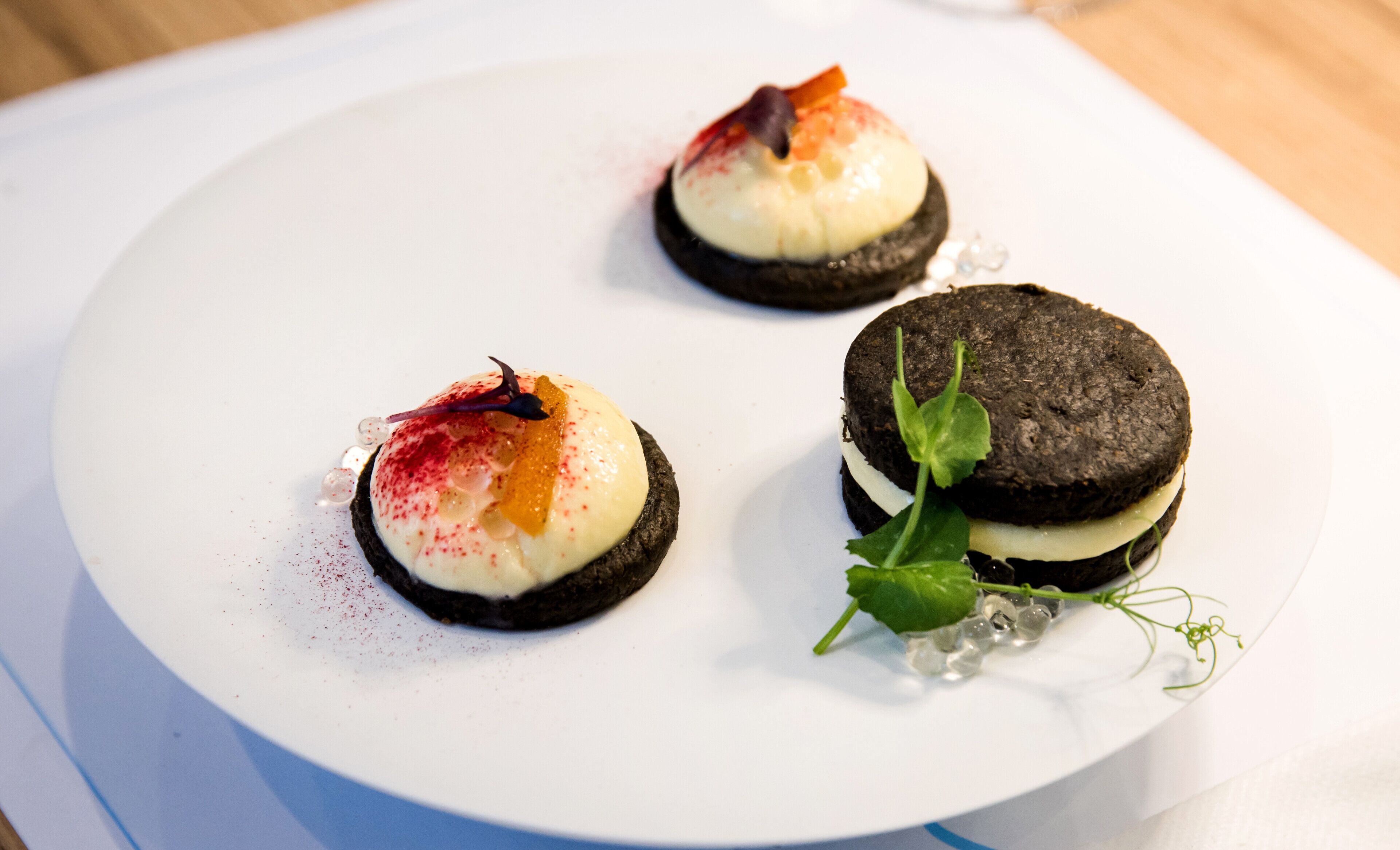 Three desserts on a white plate.