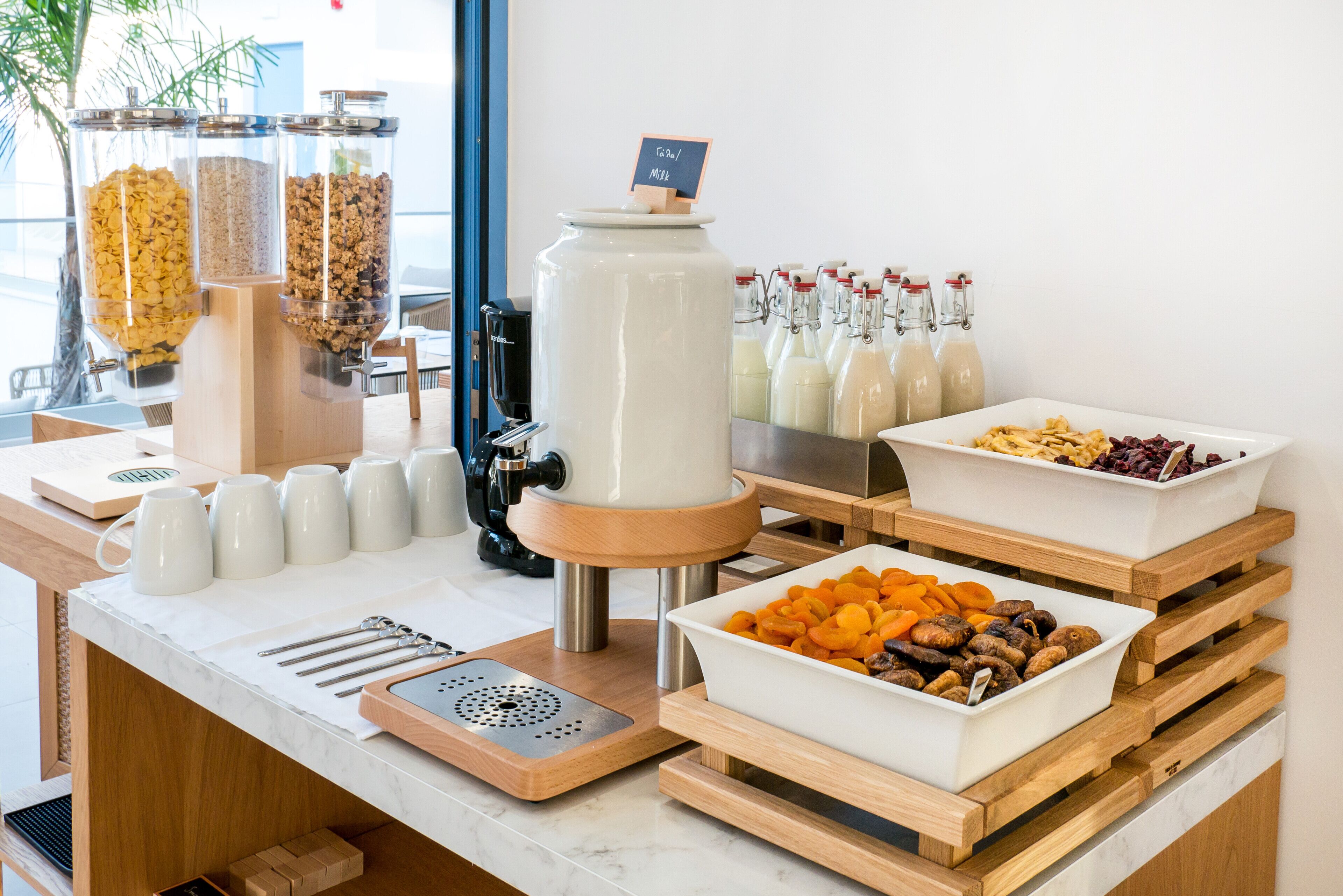 A buffet setup with various food items and a coffee machine.