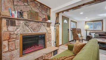 Smart TV, fireplace, books, computer monitors