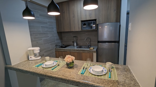 Fridge, microwave, stovetop, coffee/tea maker