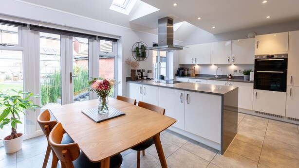 A modern kitchen with a central island, white cabinetry, and a skylight. - Luxury detached house next to Gedling Country Park. Pet friendly! (Nottingham)