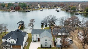 A residential area with houses near a lake, docks, and boats. - Spectacular, New Waterfront Home.  A Place to Escape and Enjoy Lake Life! (Mabank)
