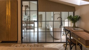 A modern bedroom with a large sliding door leading to a bathroom. - Zamek Sarny (Radkow)