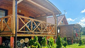 A wooden cabin with a covered porch and a bicycle rack.