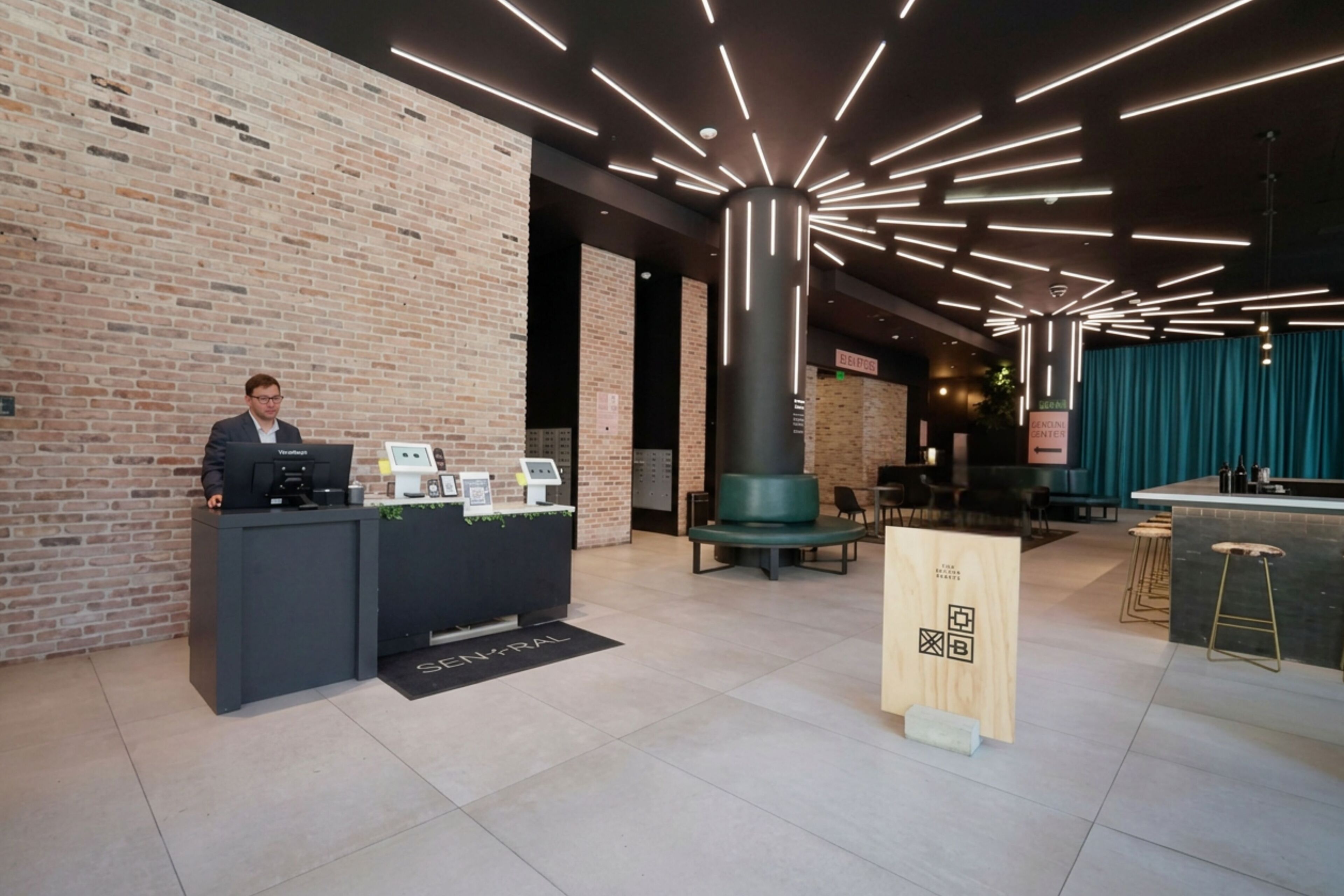 A reception desk with a coffee machine, a wooden sign with QR code, and a bar area with stools.