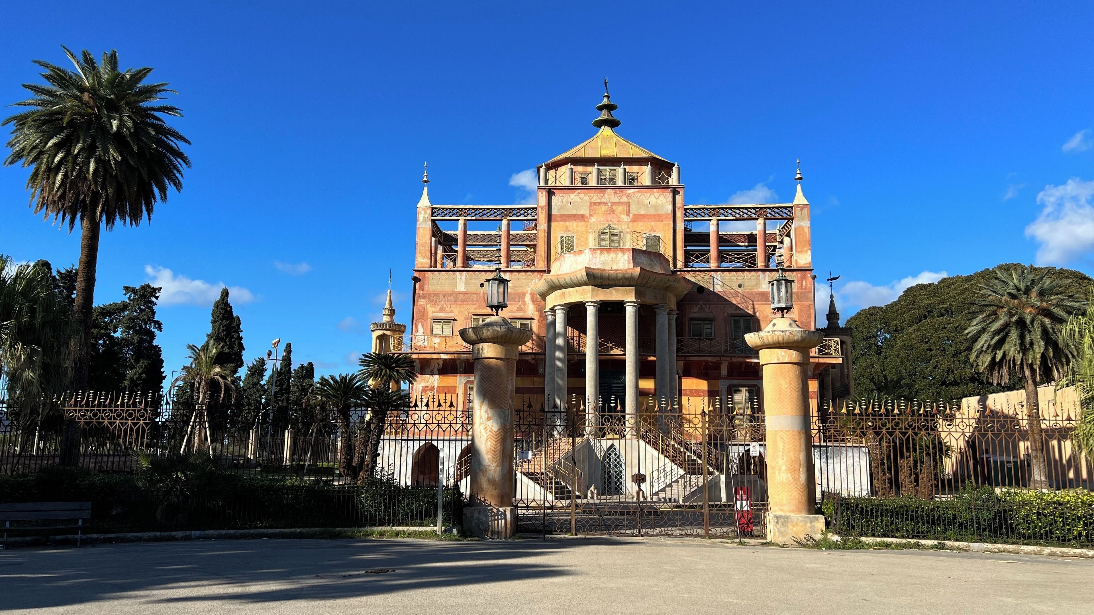 A historic building with a central dome, columns, and a staircase leading to the entrance.