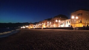 A beachside promenade with buildings, street lamps, and a view of the sea. - Playa Balerma II (Balerma)