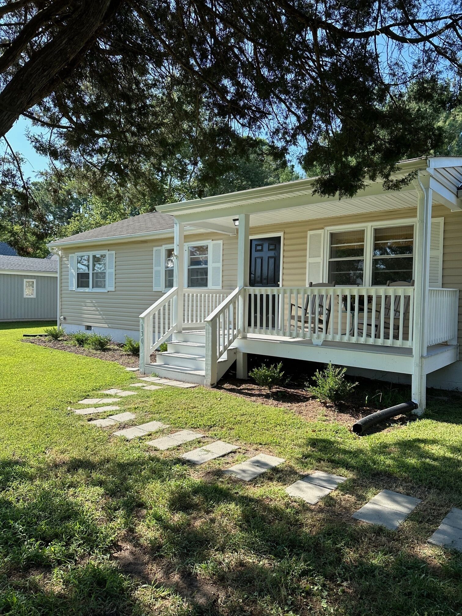 Walk to town from this cozy Rivah house with awesome yard and water views.  