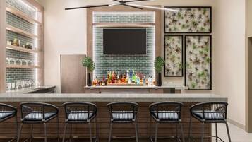 Une cuisine moderne dotée d’un coin bar, avec un mur arrière en briques, une grande fenêtre et un téléviseur à écran plat.