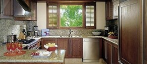 Enjoy cooking in this well-equipped kitchen with a central island, oven, and dishwasher.