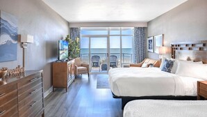 Una habitación de hotel moderna con una cama grande, un escritorio, una silla y un balcón con vistas.