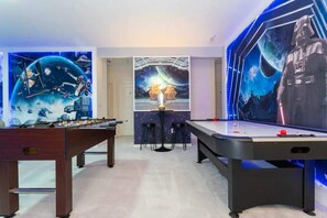 A room with a foosball table, a pool table, and Star Wars-themed wall art. - 10BD Bella Vida Beautiful Home Near Parks (BV 303) (Kissimmee)