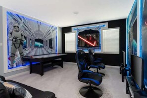 A room with a pool table, gaming chairs, a TV, and Star Wars-themed wall art. - 10BD Bella Vida Modern Home Private Pool (BV 4456) (Kissimmee)