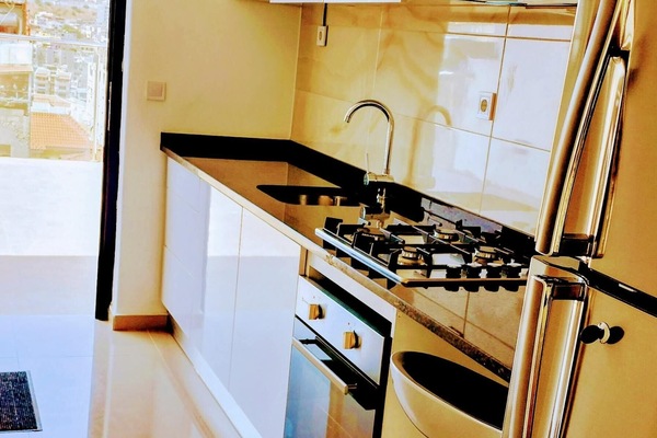 Full kitchen with gas stove & oven, refrigerator, pots, pans, dinnerware, washer