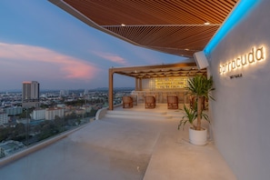 A rooftop bar with a city view, a sign reading 'barracuda SKY GALA', and a potted plant. - Akara Hotel Pattaya (Pattaya)