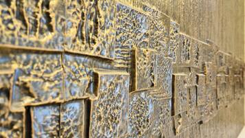 A close-up of a textured wall with intricate carvings.