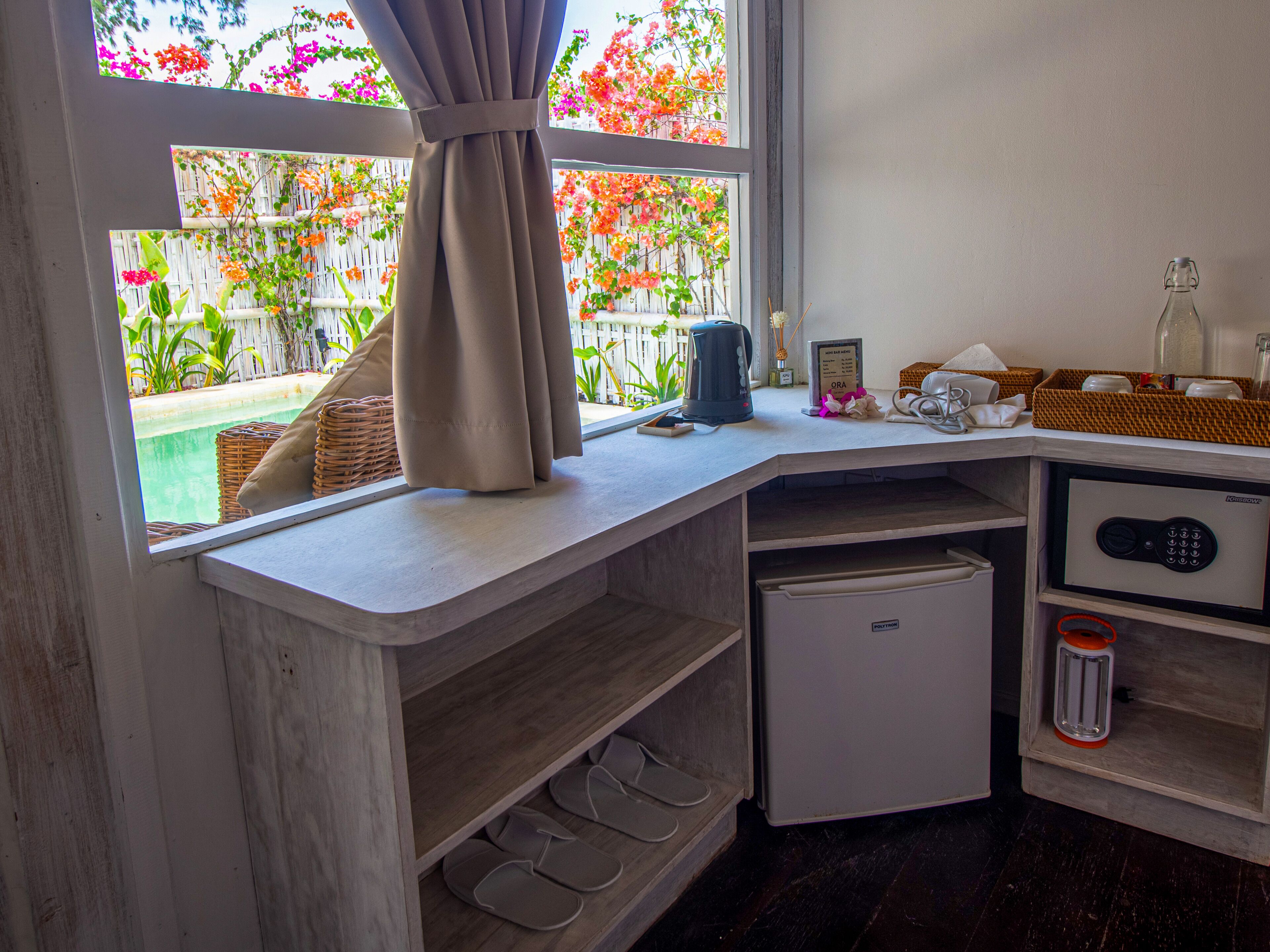 A kitchen with a built-in refrigerator, a coffee maker, and a small sink.