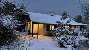 A snow-covered house with a visible garage and a covered outdoor seating area. - "Alica" - 200m from the sea by Interhome (Nexø)