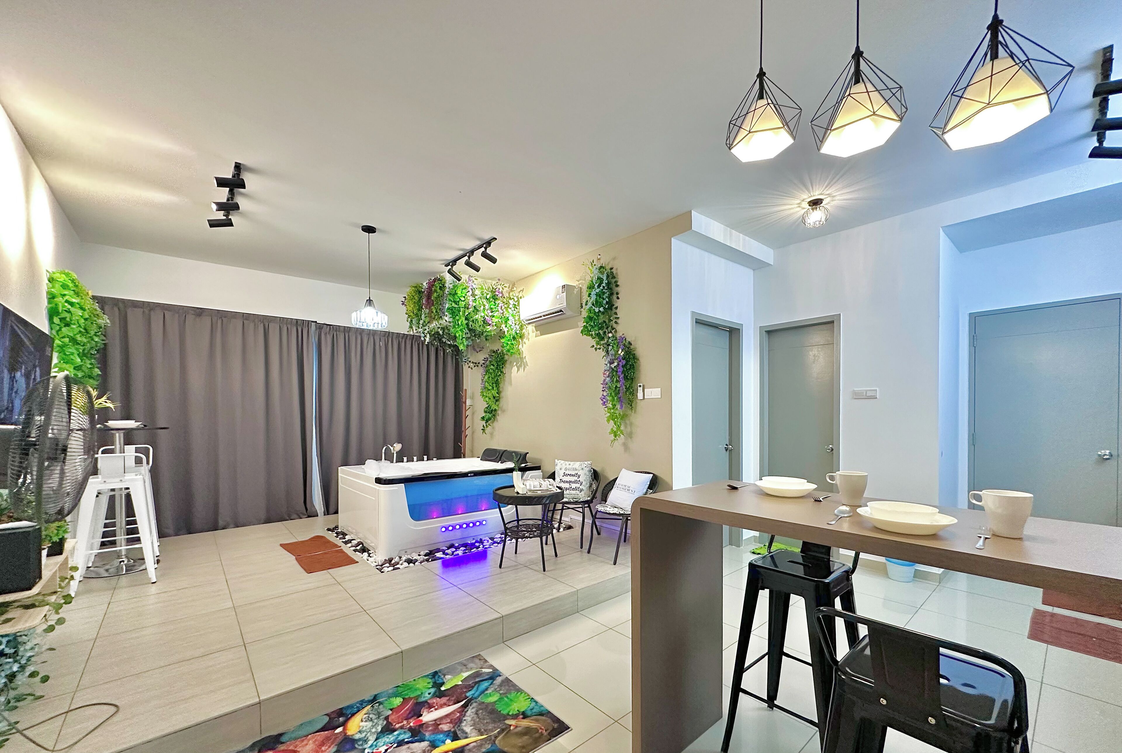 A modern kitchen with a central island, bar stools, and a dining table.