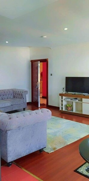 Business Apartment | Living area | 24-inch Smart TV with digital channels - Lux Suites Fahari Palace Apartments (Nairobi)