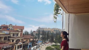 A balcony with a view of a cityscape, including buildings and a clear sky. - Tung Lam Hotel Sapa - by Bay Luxury (Sa Pa)