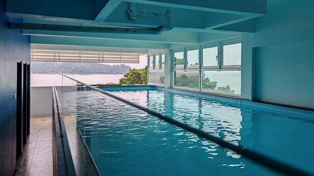 A swimming pool with a view of a body of water and distant land. - Pangkor Pop Ash Hotel (Pangkor Island)