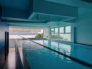 A swimming pool with a view of a body of water and distant land. - Pangkor Pop Ash Hotel (Pangkor Island)