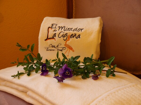 A pillow with text and a floral arrangement.