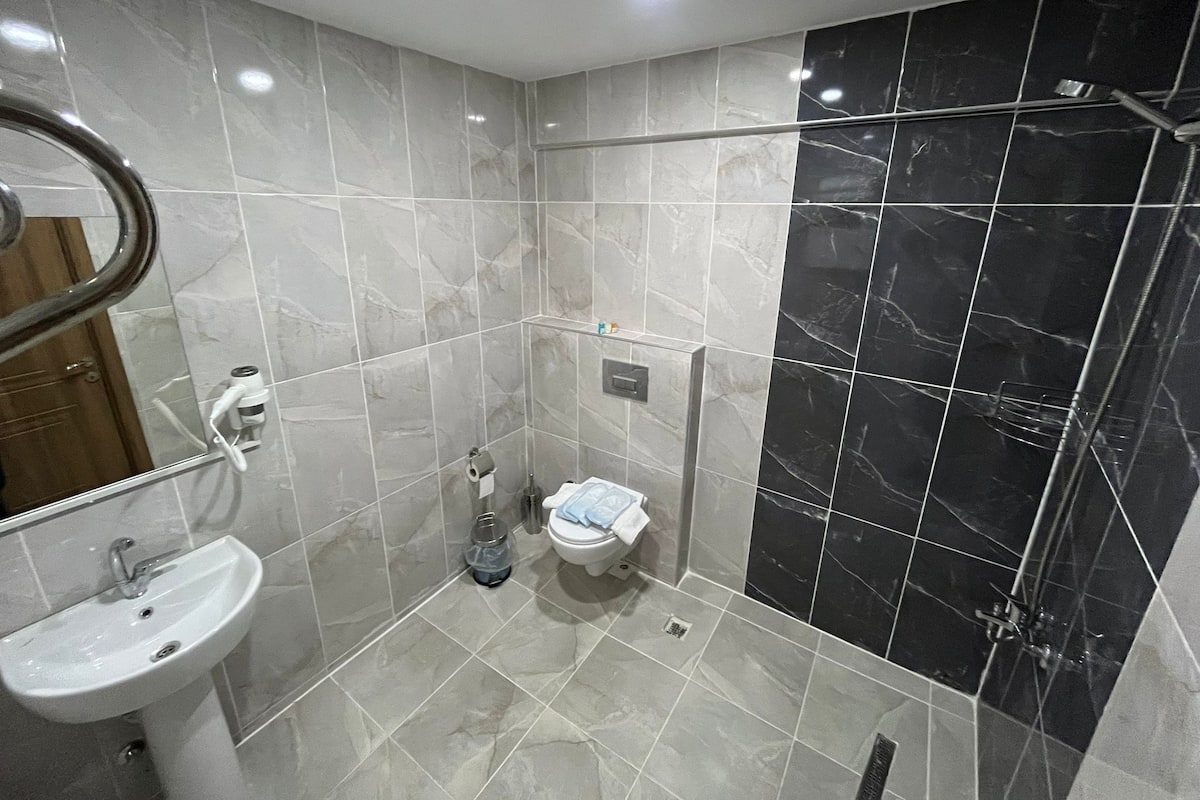 Rainfall showerhead, designer toiletries, hair dryer, slippers