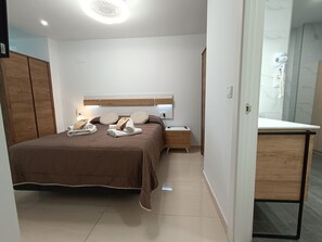 1 bedroom, desk, iron/ironing board, travel crib