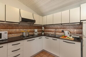 Fridge, microwave, stovetop, coffee/tea maker