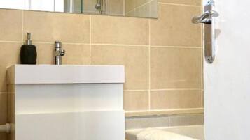 Shower, hair dryer, towels, toilet paper