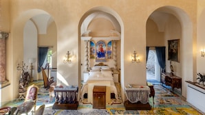 A grand hallway with arches, a central altar, and a colorful tiled floor. - Villa Barluzzi (Ravello)