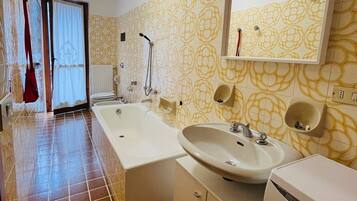 A bathroom with two sinks, a shower, and a toilet.