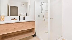 A modern bathroom with a wooden vanity, a large mirror, and a glass shower enclosure. - Queenstown Mountain Vista, quick walk to town centre. (Queenstown)