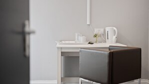 A minimalist room with a white desk, a coffee maker, and a chair. - Queensferry guest house (Dunfermline)