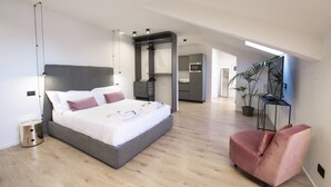 A modern bedroom with a large bed, bedside tables, a desk, and a chair. - SAN CARLO SUITE TORINO (Turin)