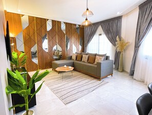 Signature Apartment | Living area | 32-inch Smart TV with digital channels