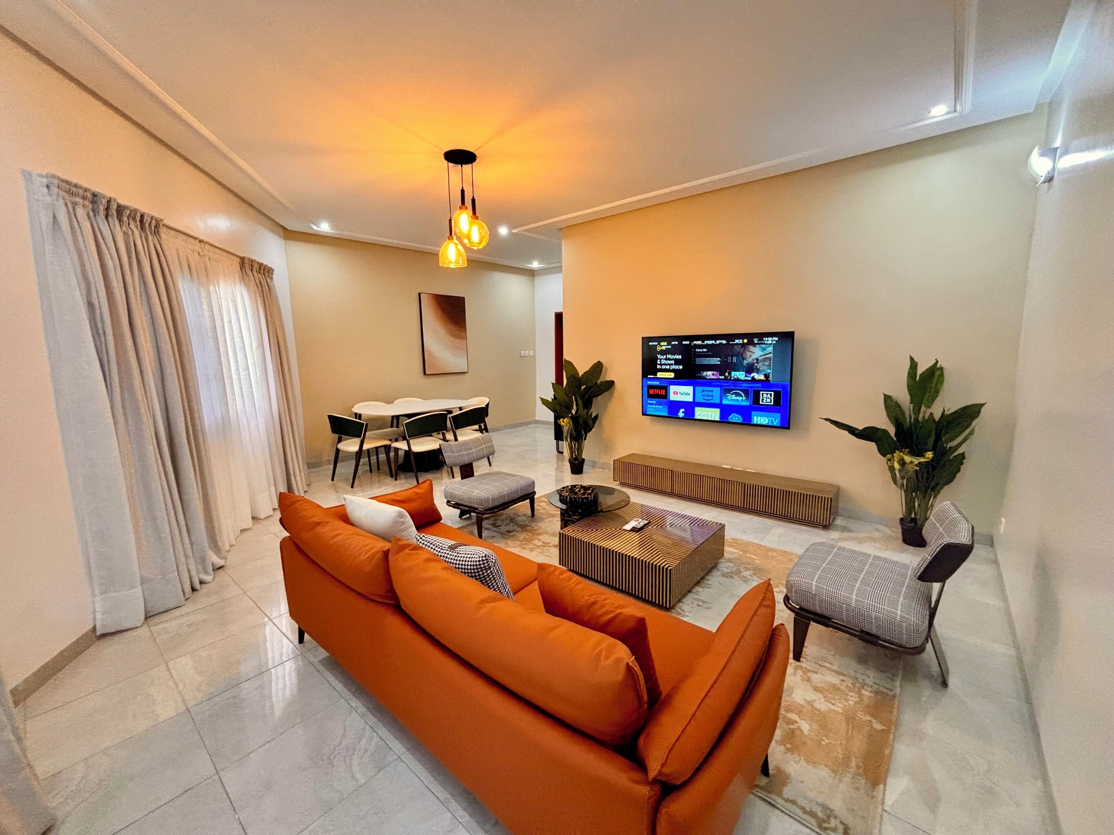 A modern living room with a sofa, coffee table, and TV.