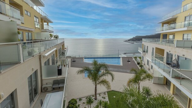 A modern building with a pool, balconies, and a view of the sea. - Sea Sound Apartment by Trip2Portugal (Sesimbra)