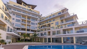 A multi-story hotel with a swimming pool in the foreground. - Sea Sound Apartment by Trip2Portugal (Sesimbra)