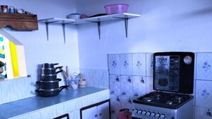 A compact kitchen with a gas stove, a built-in oven, and a small countertop. - Lux Suites Chief Engineer Apartments (Mwingi)