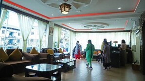 A hotel lobby with seating areas, a reception desk, and large windows. - Punakha Residency Hotel (Punakha)
