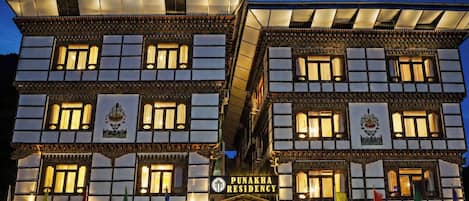 A multi-story building with a sign reading 'PUNAKHA RESIDENCY.'