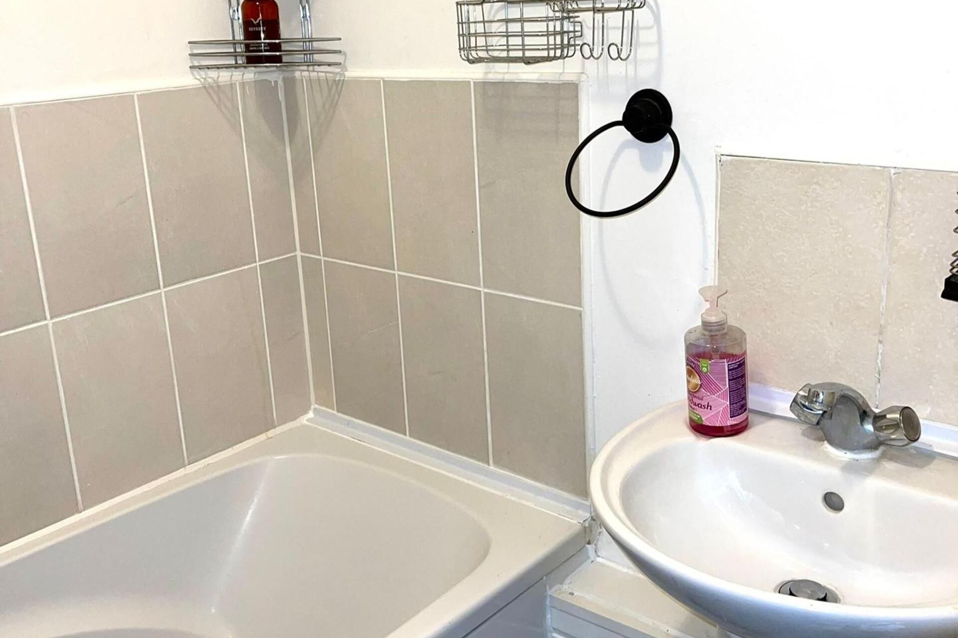 A bathroom with a bathtub, a sink, and a shower.