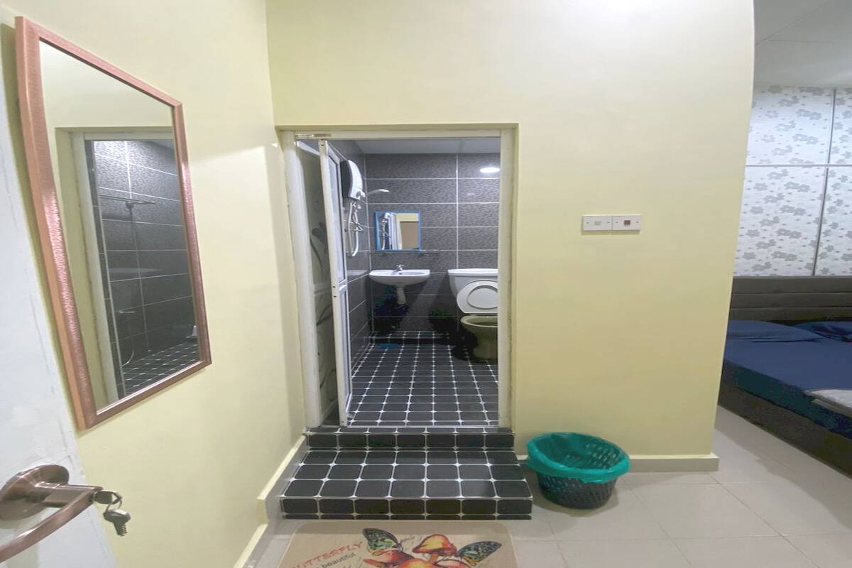 A narrow hallway leading to a bathroom with a sink and toilet.
