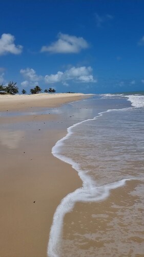 House in a gated community surrounded by green spaces 150 meters from the beach.