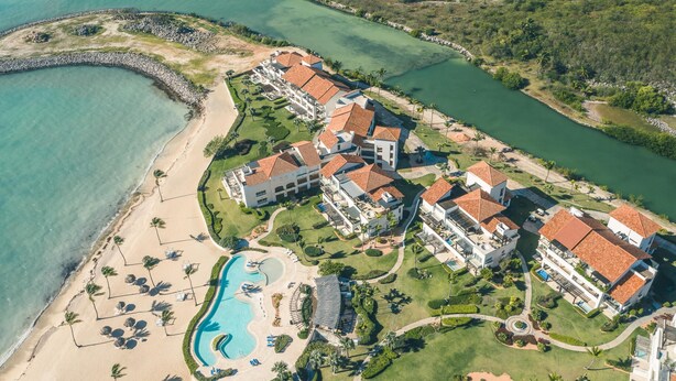 An aerial view of a resort with multiple buildings, a beach, and a swimming pool. - Modern Studio With Ocean View in Punta Palmera (Punta Cana)