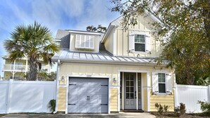 A two-story house with a garage, a front door, and a small porch. - Beautiful House-Owner's Secrete Treasure, Private Backyard, 3 min to the Beach! (Myrtle Beach)