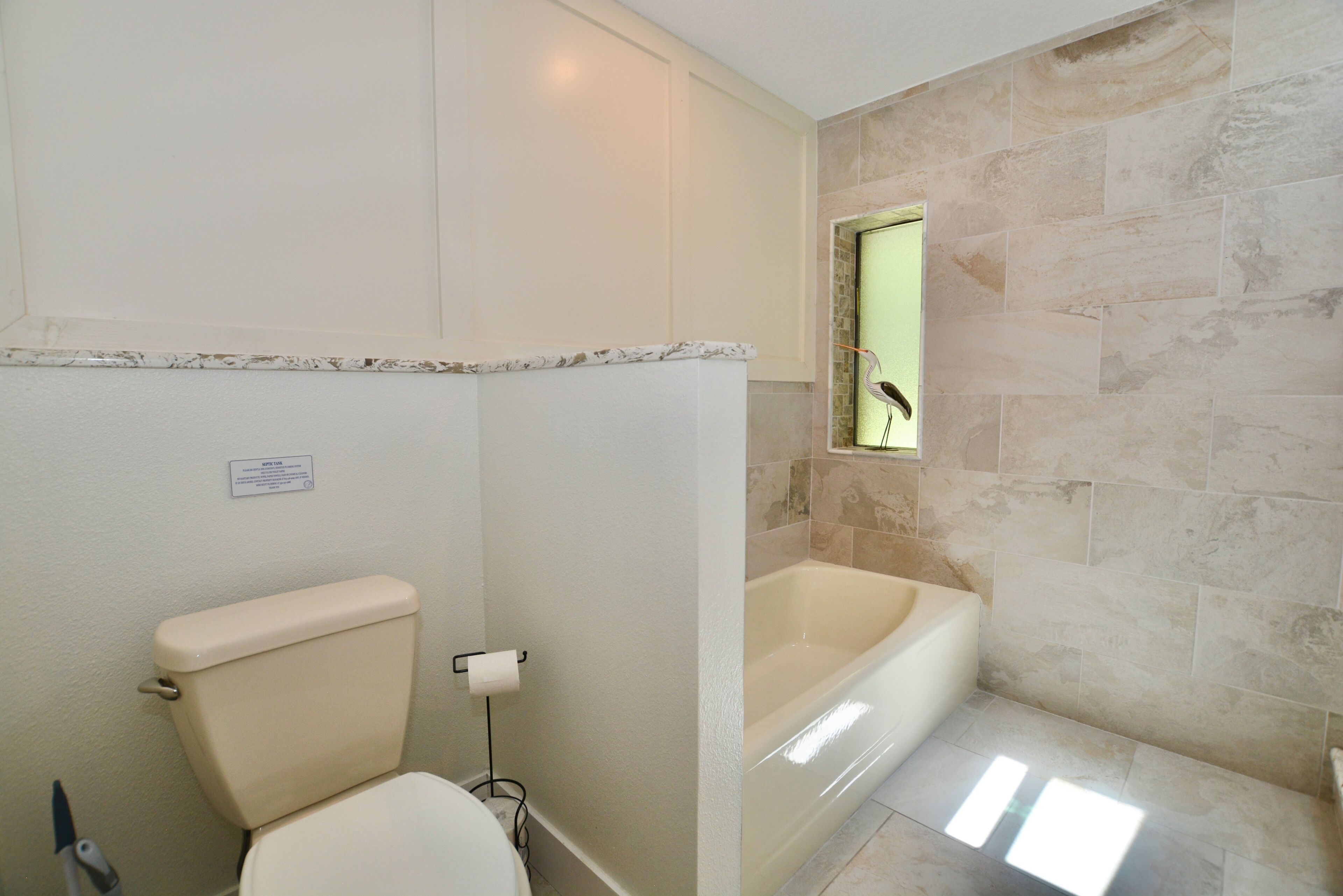 A bathroom with a toilet, a bathtub, and a shower.